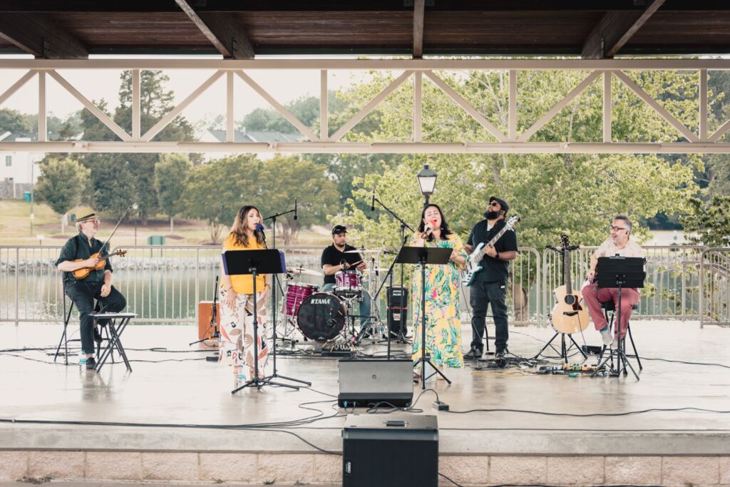 A photo of Ana Lucia Divins (fourth from left) performing with Café Amaretto. 