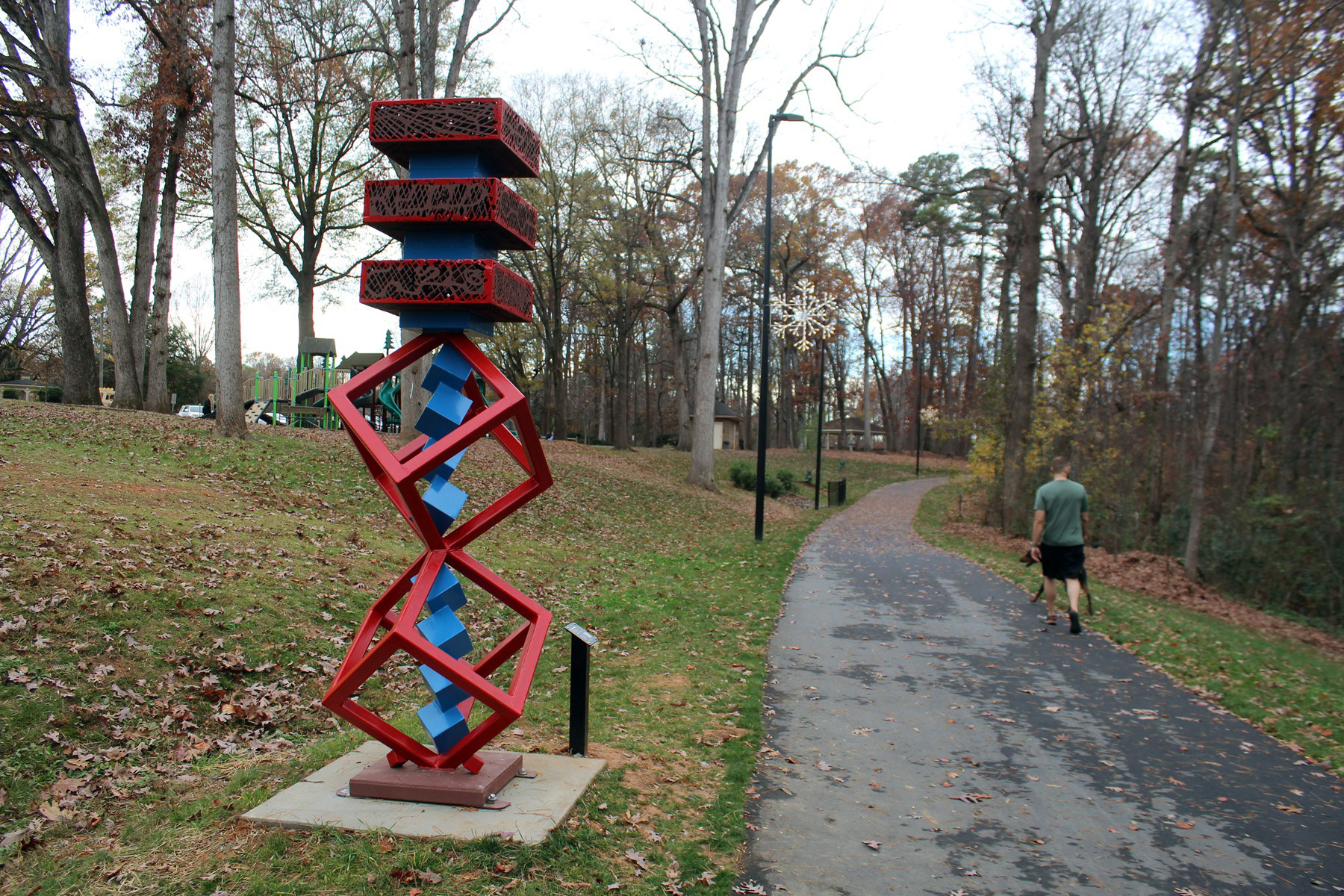 The steel-and-cast-iron sculpture “Cube in Motion,” by Hanna Jubran, is one of the six artworks found in the SculpTOUR exhibition in Huntersville's Holbrook Park, along the downtown greenway. 