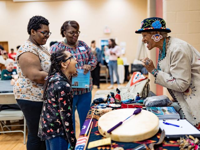 Charlotte storyteller Ramona Moore Big Eagle (right) engages residents at a Culture Blocks event.